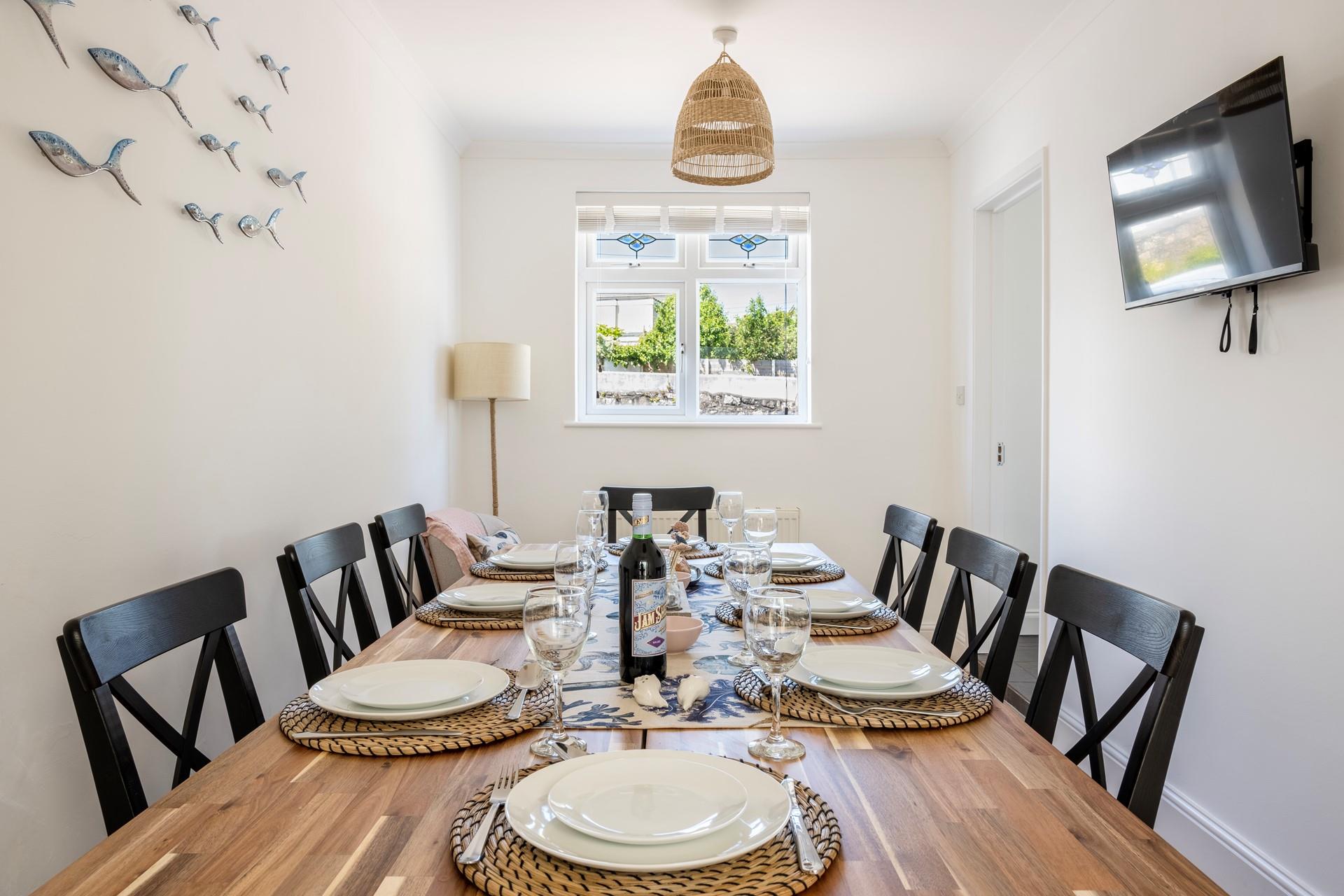 The dining room is stylish complete with a TV!
