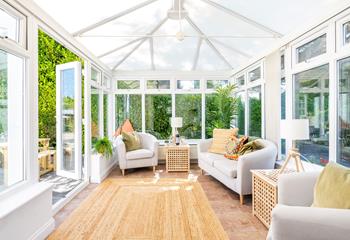 The conservatory has additional seating to relax and unwind.