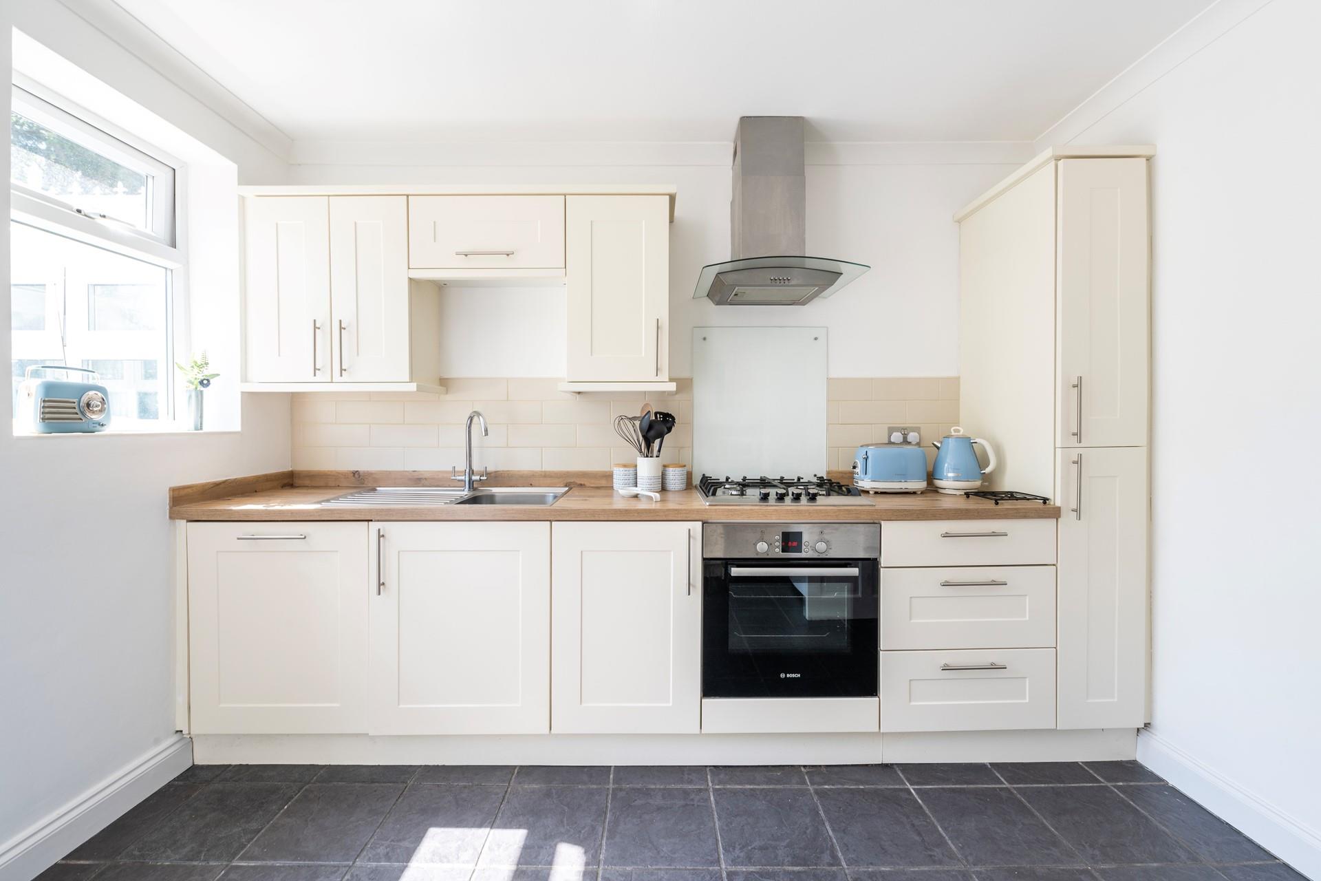 The kitchen is stylish and well-equipped for cooking tasty meals.