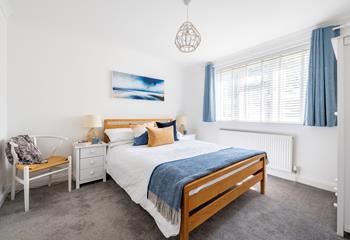 Bedroom 3 is decorated with seaside blues and yellows.