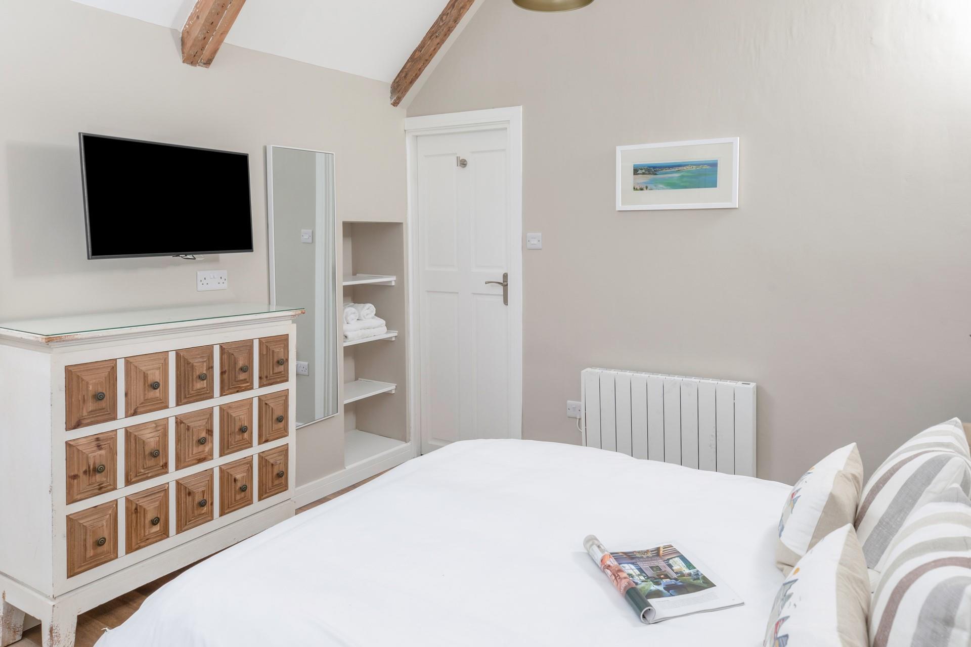 Bedroom 2 is decorated in neutral tones creating a calming space to relax.