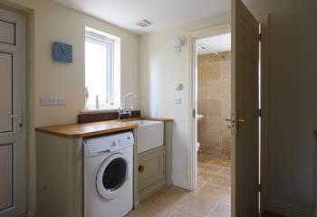 The utility room has a washing machine and tumble dryer.