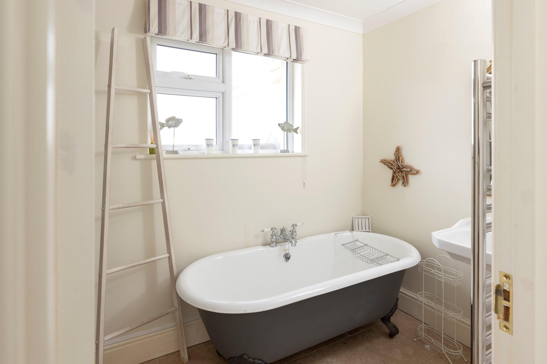 The family bathroom has a free-standing bath for relaxing soaks in the bubbles.