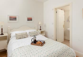 The bedrooms each have a wardrobe and a chest of drawers.