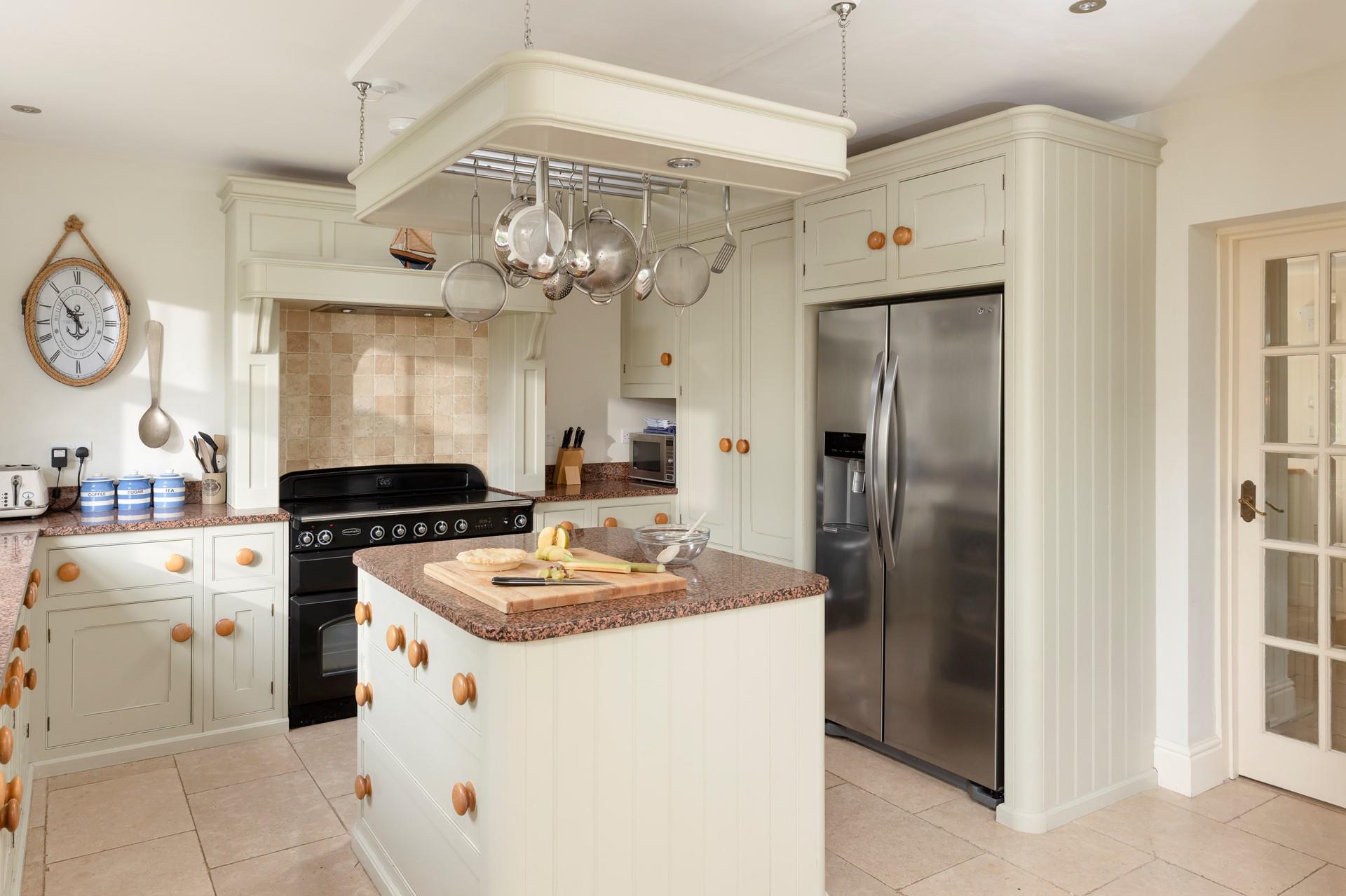 The kitchen features an island and a handy American-style fridge freezer.