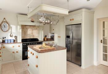 The kitchen features an island and a handy American-style fridge freezer.