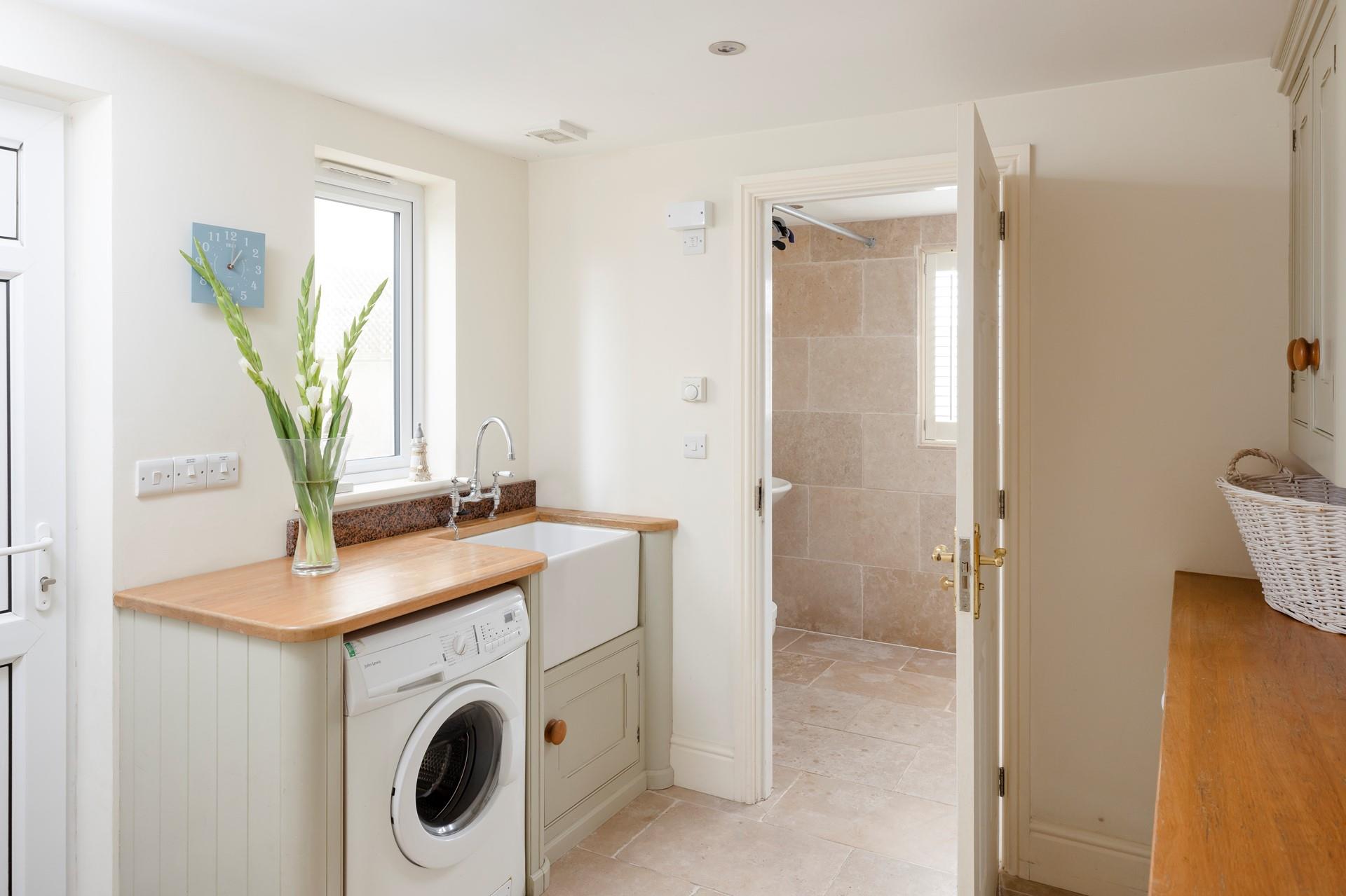 The utility room has a washing machine and tumble dryer.