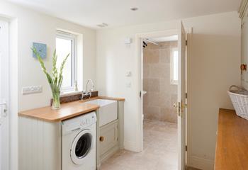 The utility room has a washing machine and tumble dryer.