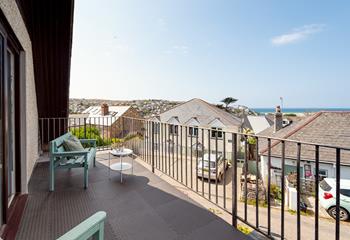 Soak up the sea views from the balcony with a glass of something cold.