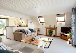The comfortable sitting room is a place to unwind and spend quality time together as a family.