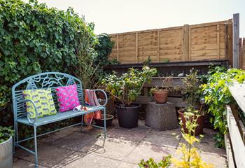 The back patio has a bench to enjoy morning coffee as the sun comes up.