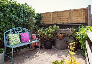 The back patio has a bench to enjoy morning coffee as the sun comes up.