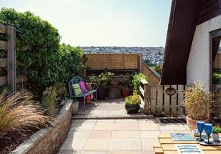 Enjoy al fresco dining on the patio in the summer sunshine.
