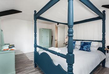 Bedroom 3 is stylishly decorated with pops of blue and green.