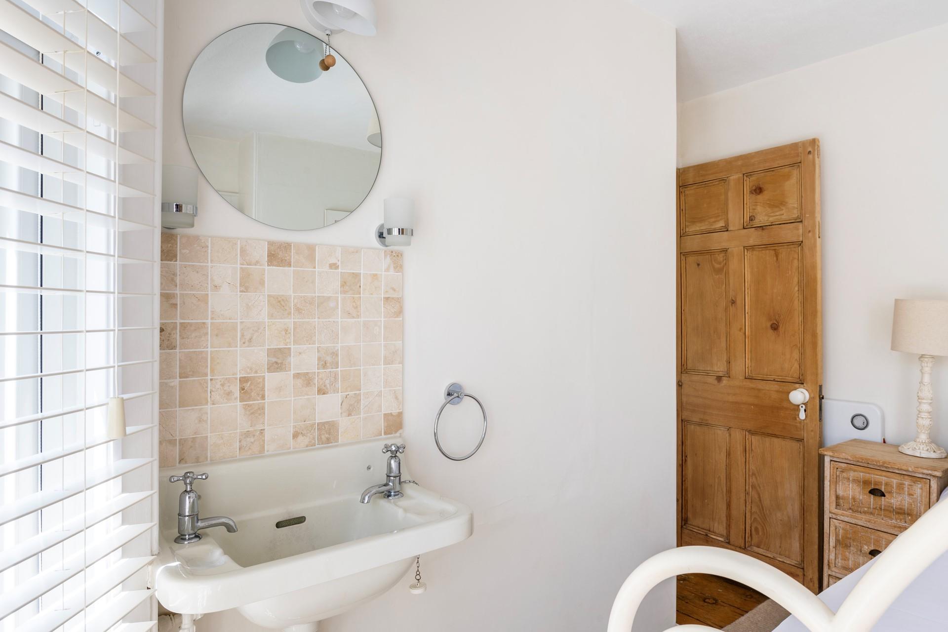 Bedroom 1 has sea glimpses across the rooftops.