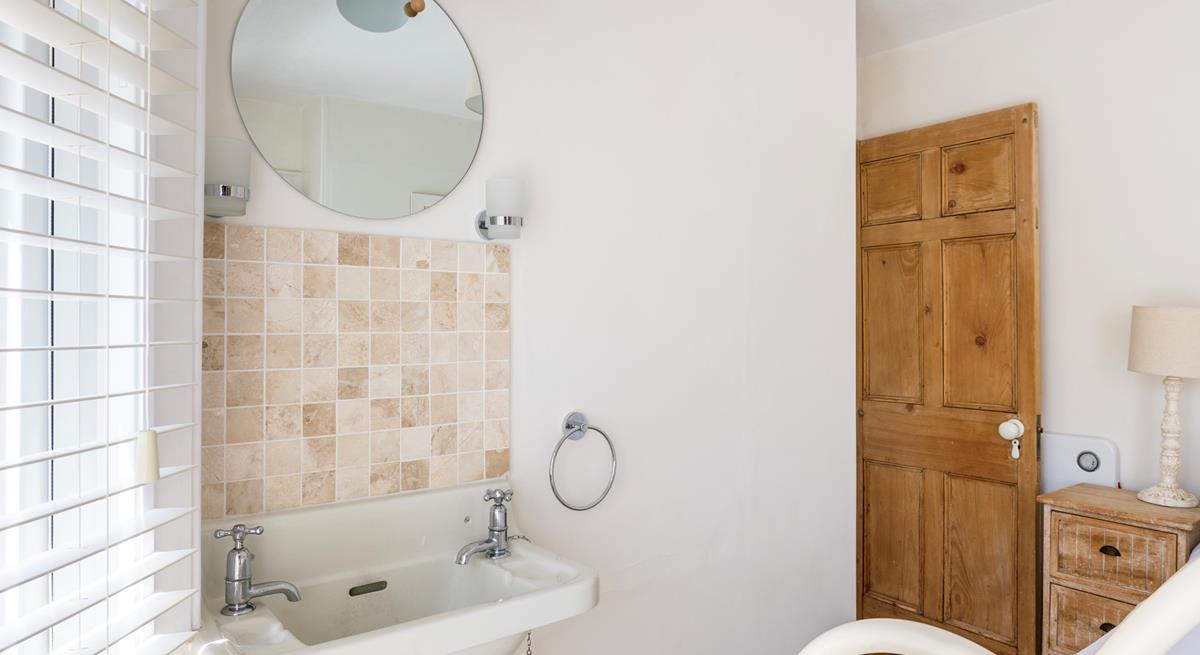 Bedroom 1 has sea glimpses across the rooftops.