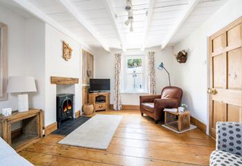 The sitting room is spacious with room for the whole family to relax.