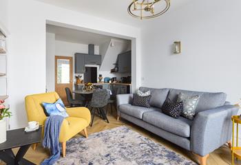 Calming grey tones with a pop of yellow create a stylish and welcoming open plan living space.