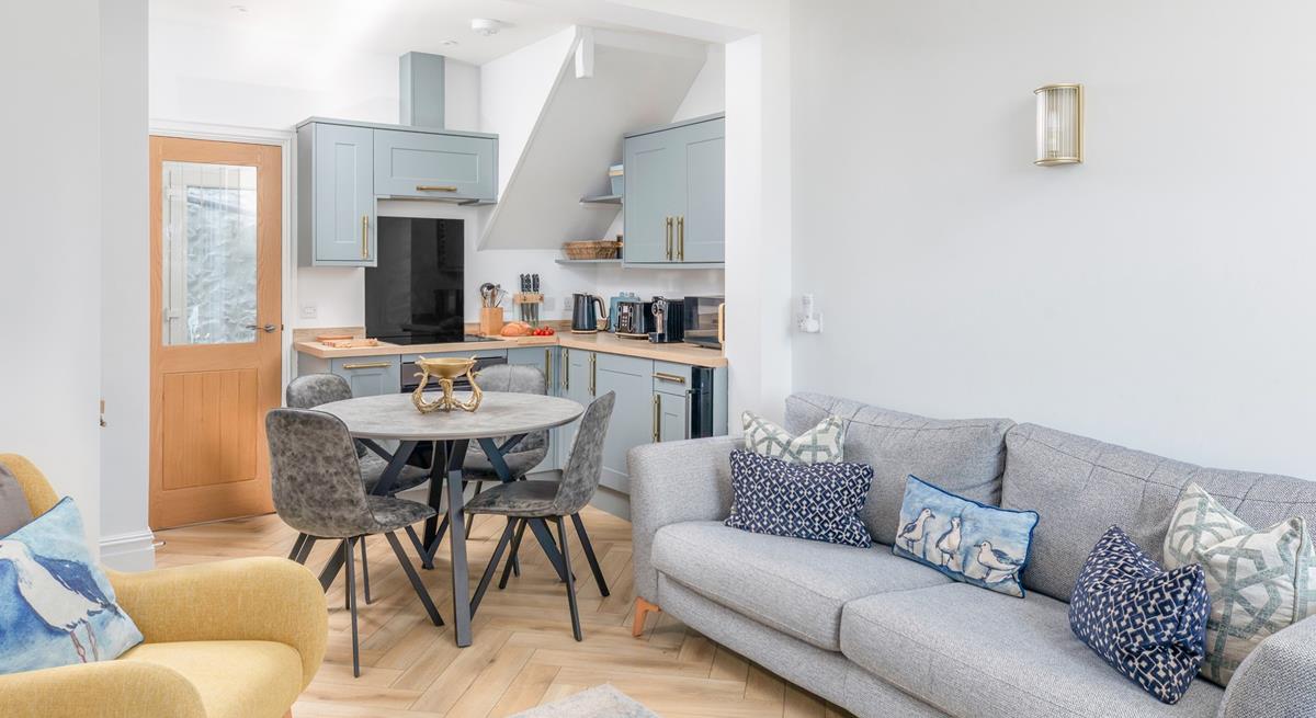 Calming grey tones with a pop of yellow create a stylish and welcoming open plan living space.