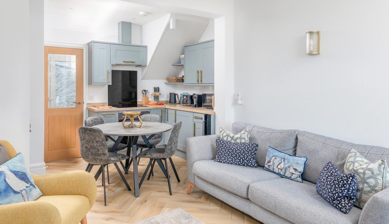 Calming grey tones with a pop of yellow create a stylish and welcoming open plan living space.