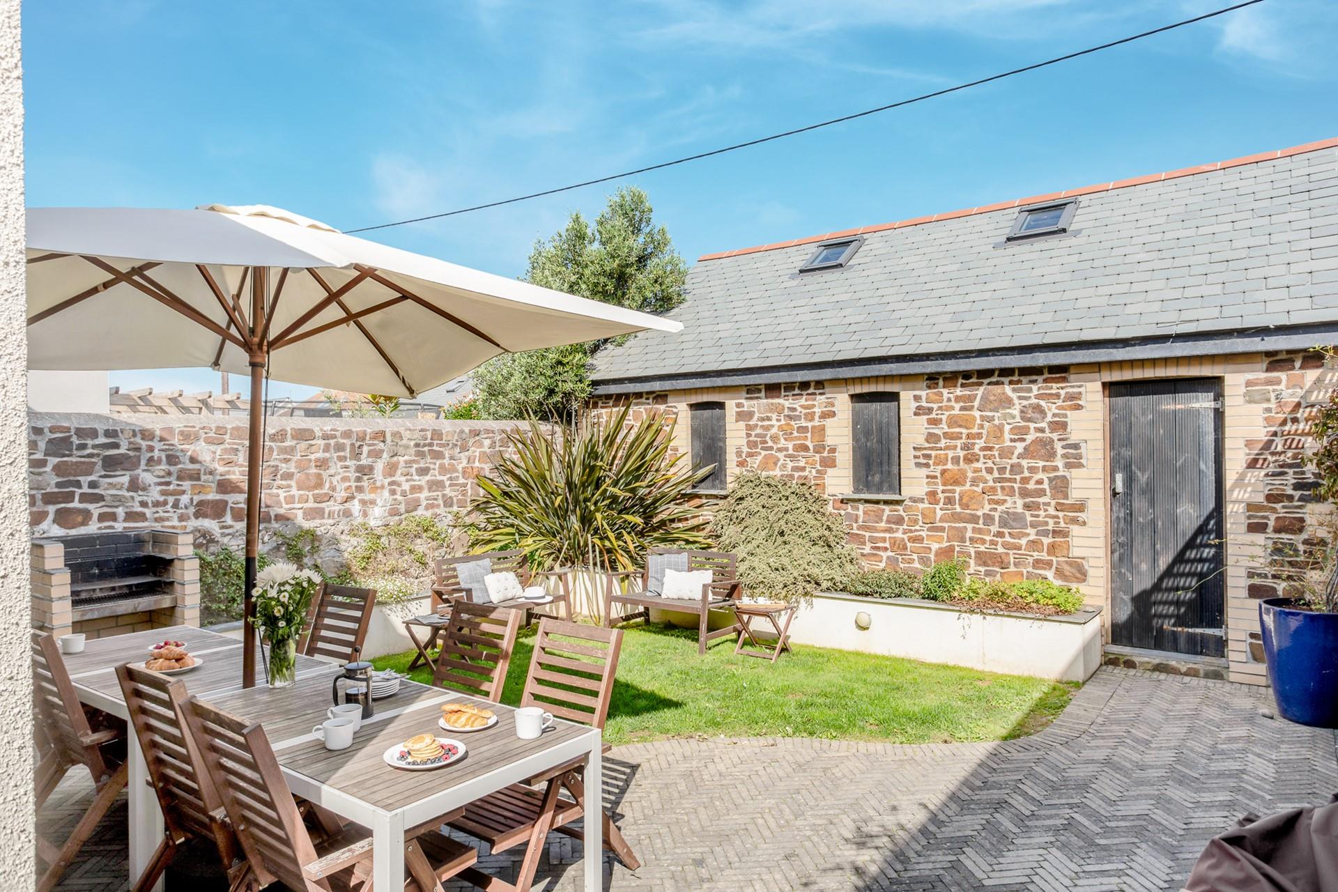 The garden has plenty of seating for guests to enjoy al fresco dining or simply relaxing in the sun.