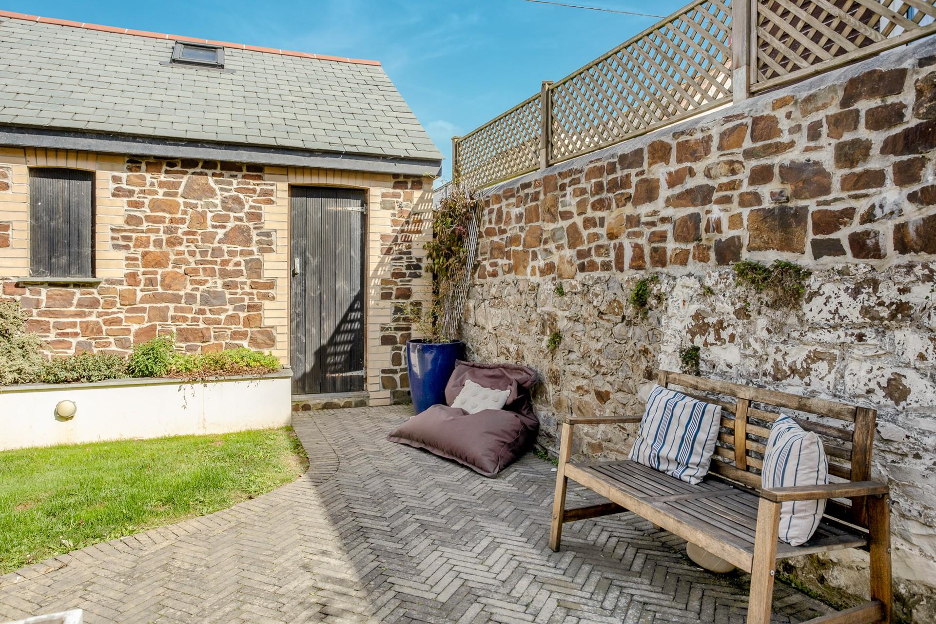 Sunbathe in the garden with a cold drink in hand.