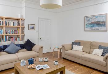 The sitting room is stylishly decorated in calming tones, perfect for relaxing with a cuppa.