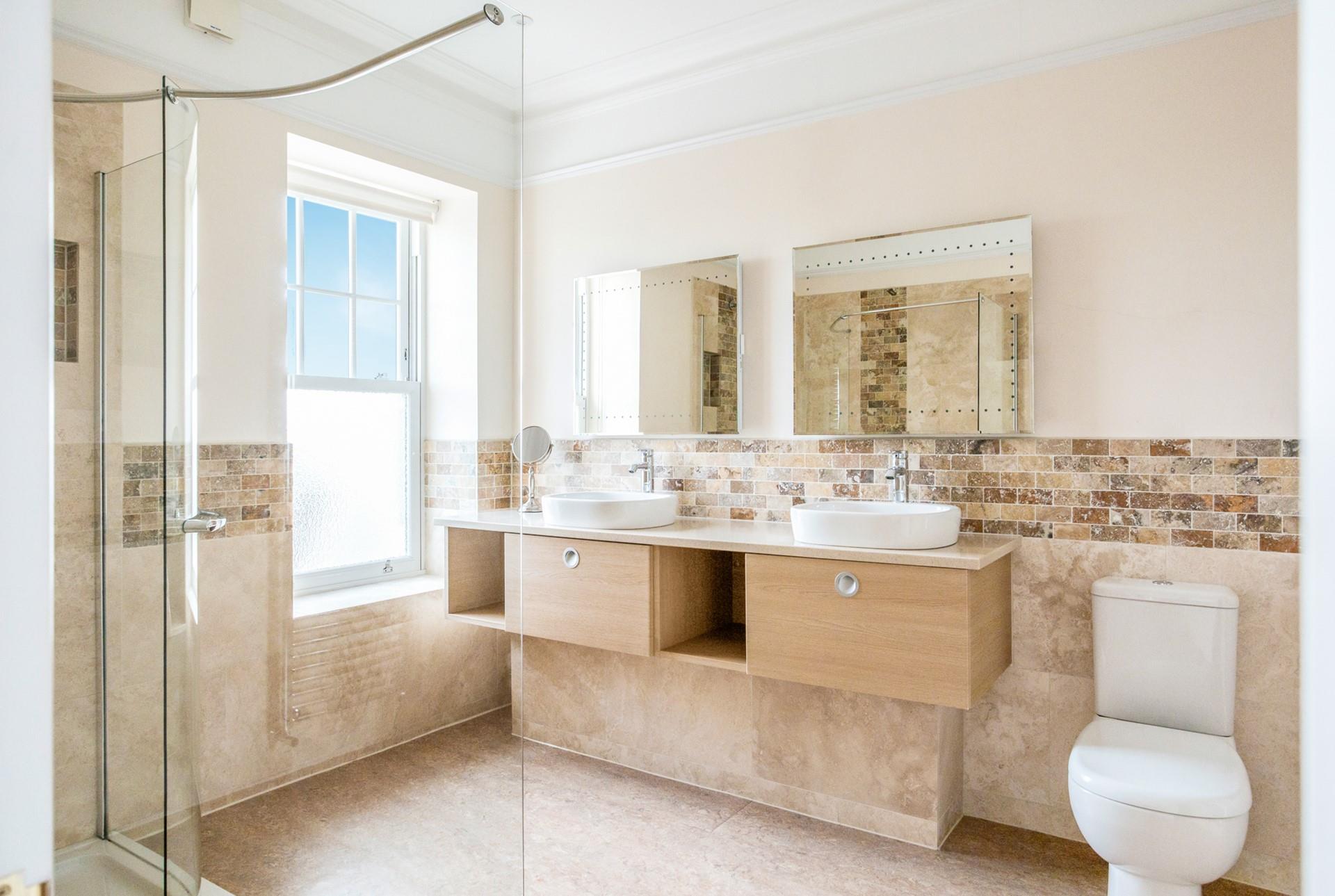 The bathroom is modern and sleek, the perfect space to get ready.