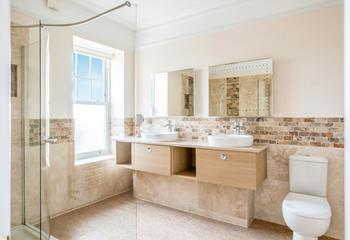 The bathroom is modern and sleek, the perfect space to get ready.