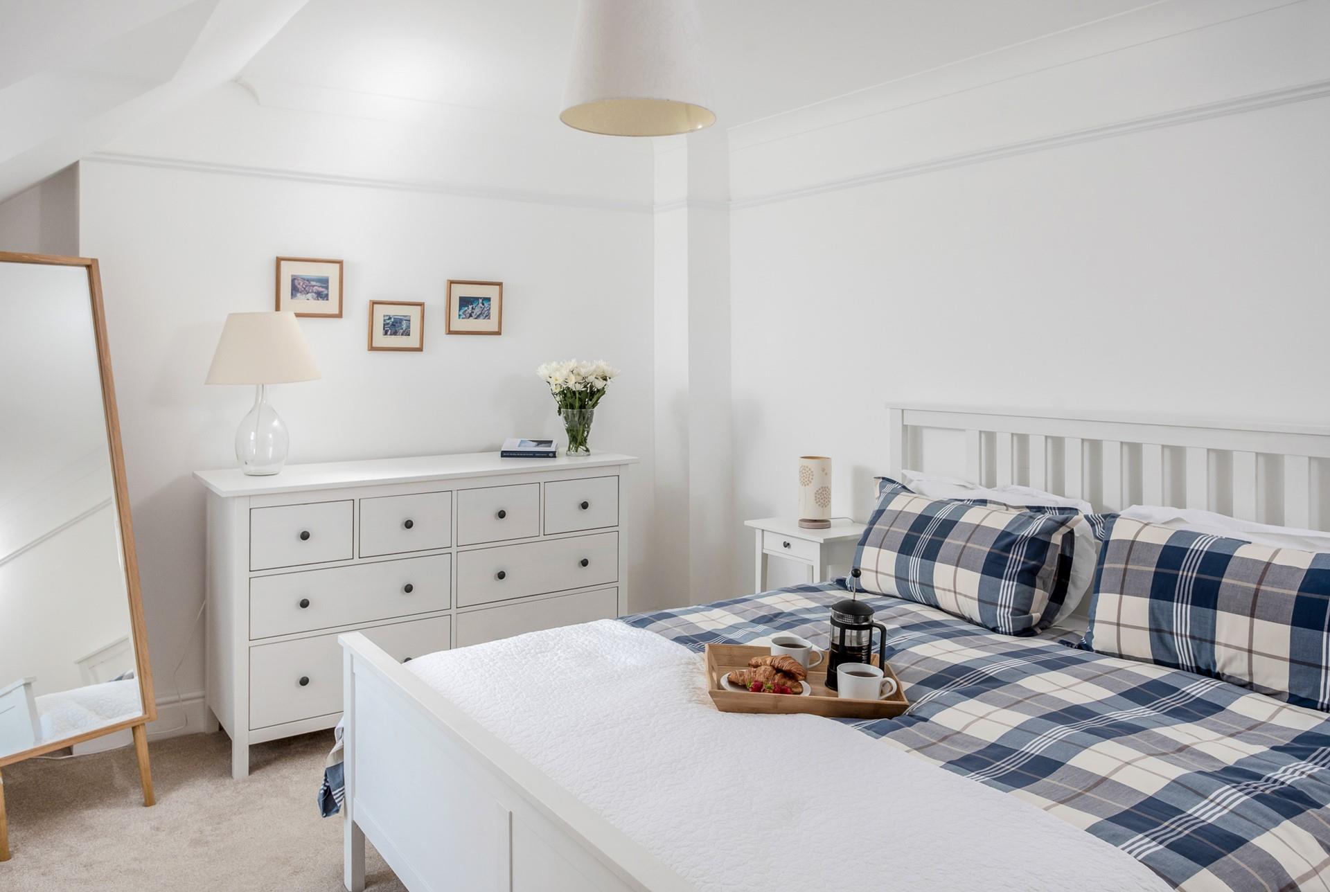 The bedrooms are decorated with blue and white tones, a calming space to relax each night.