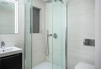 The modern shower features a handy shelf and is perfect for washing salty hair and sandy feet.
