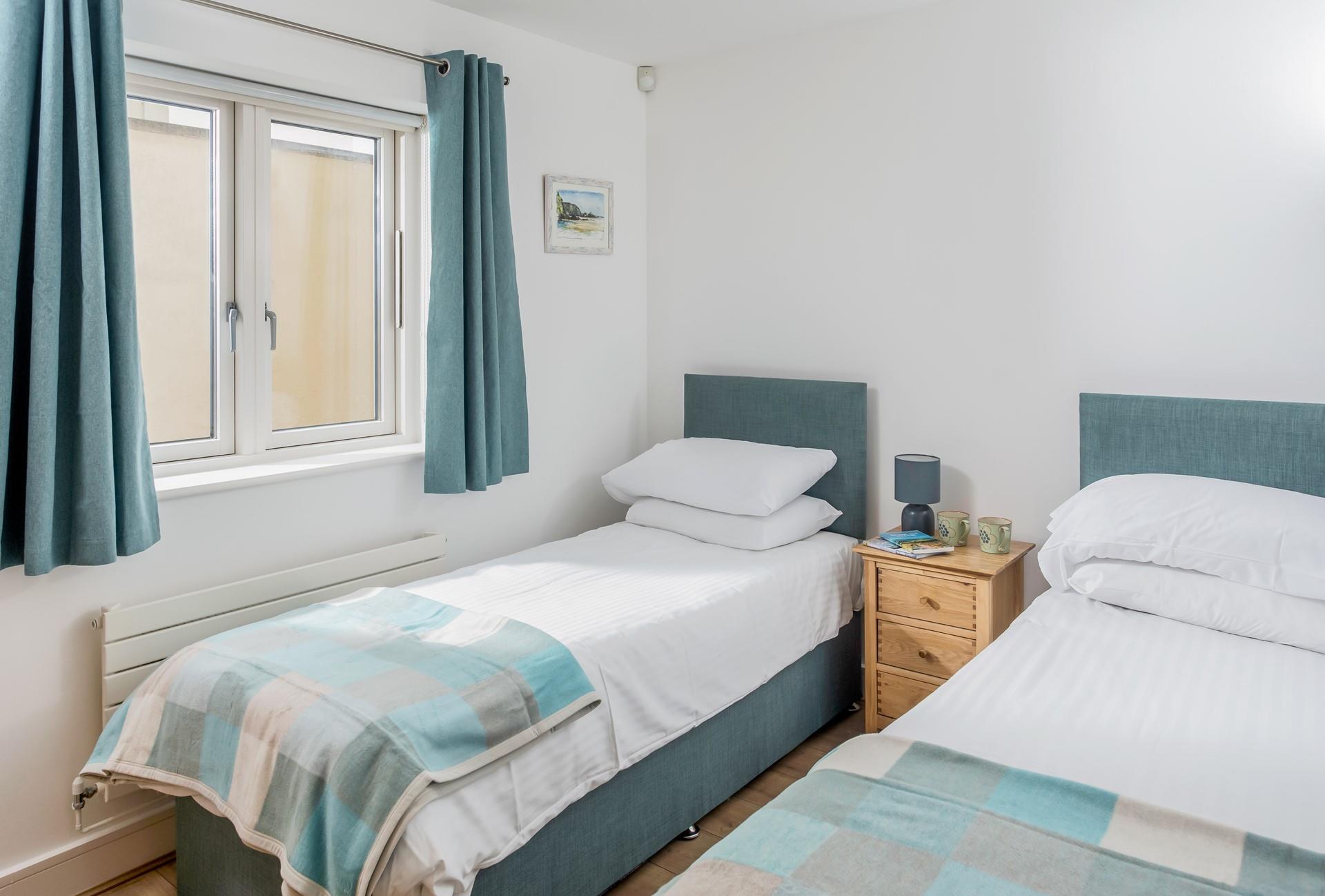 Pastel blues create a calming twin bedroom.