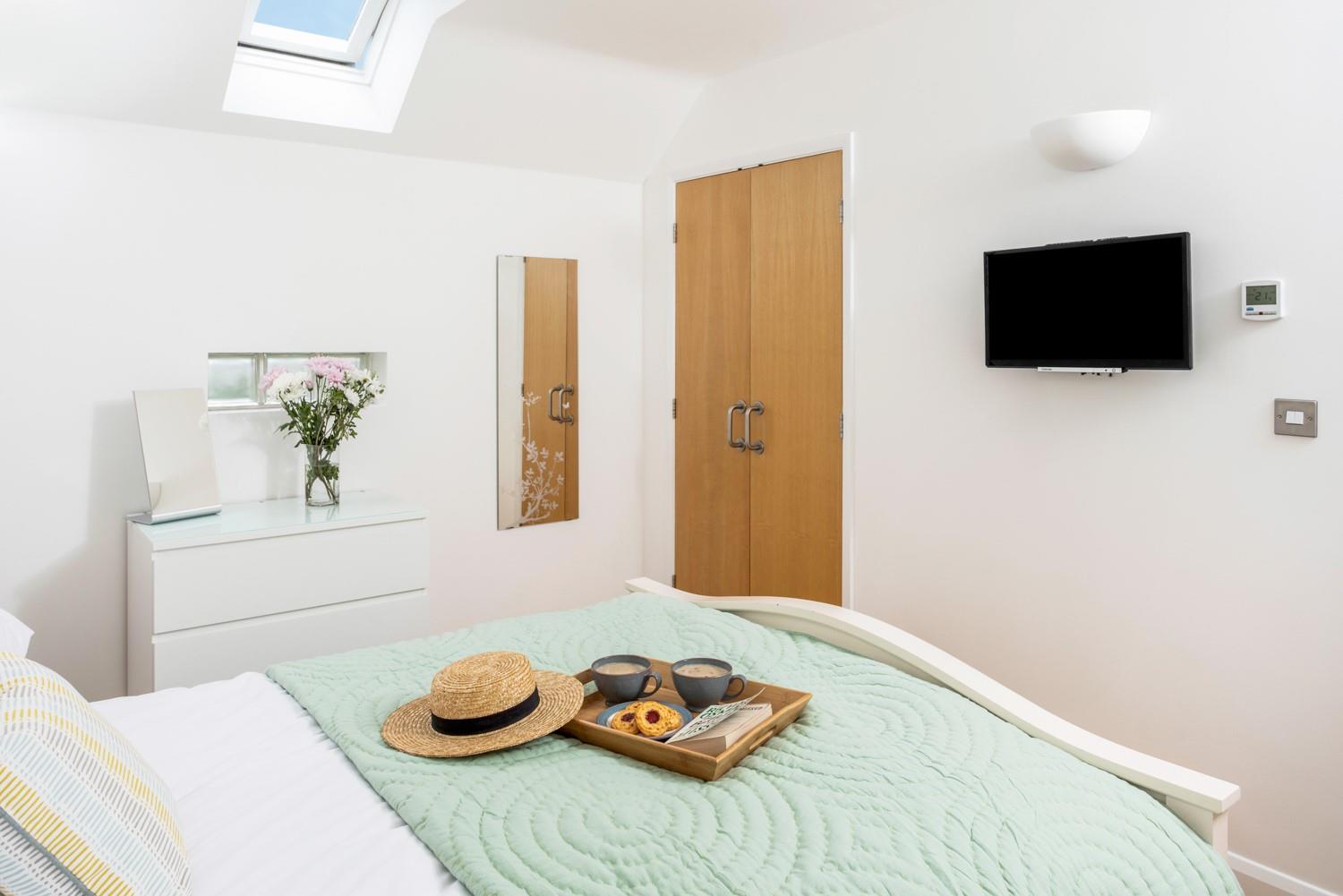 Simple styling create a relaxing retreat in bedroom 1.