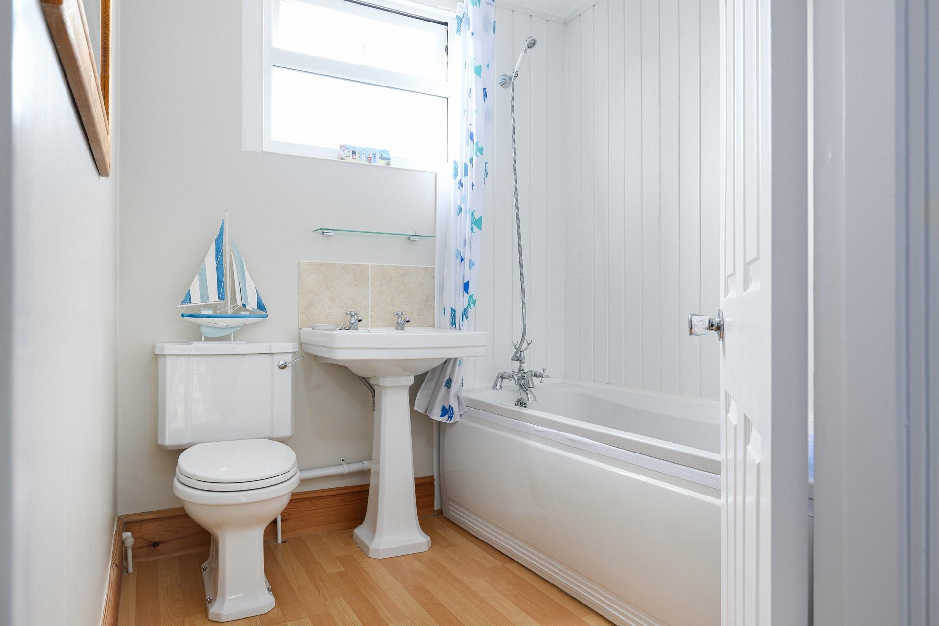 Rinse sandy toes in the seaside-inspired family bathroom after a day on the beach.