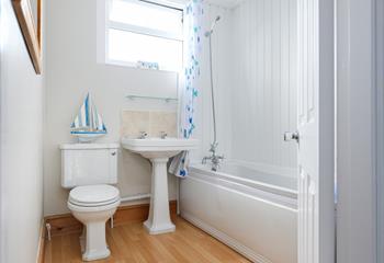 Rinse sandy toes in the seaside-inspired family bathroom after a day on the beach.