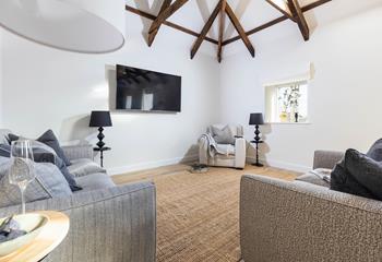 The open-plan living area features impressive vaulted ceilings and is full of light.