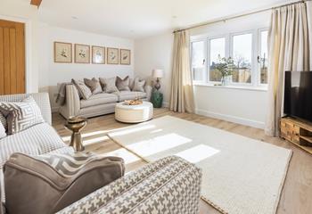 The sitting room is stylish with plenty of space to relax together on the sumptuous sofas.