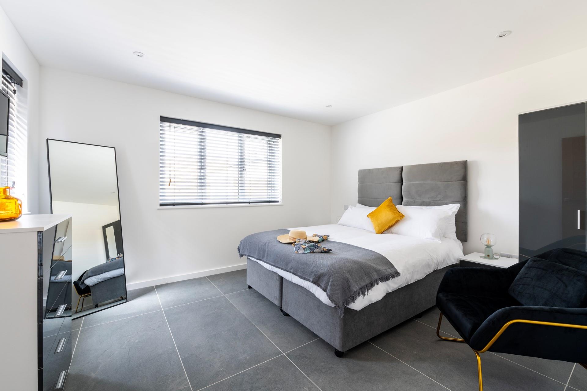 Bedroom 1 is on the ground floor and is decorated with neutral grey tones.
