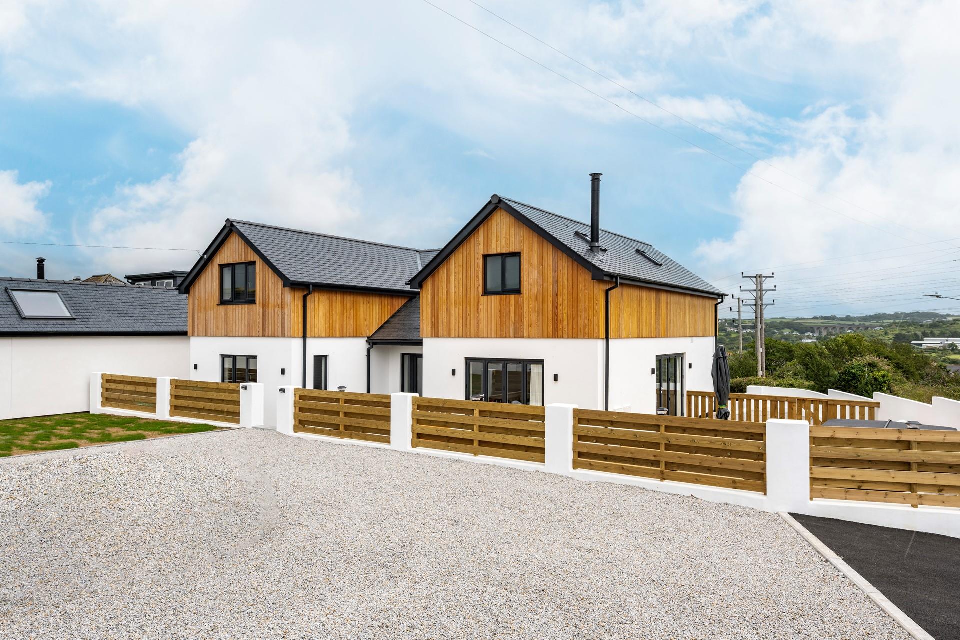 The large parking area outside has plenty of space for 2 cars.