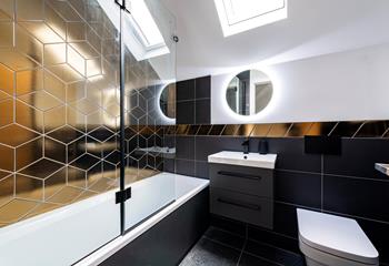 The bathroom is stylish, perfect for washing off after beach days and getting ready for evenings out.