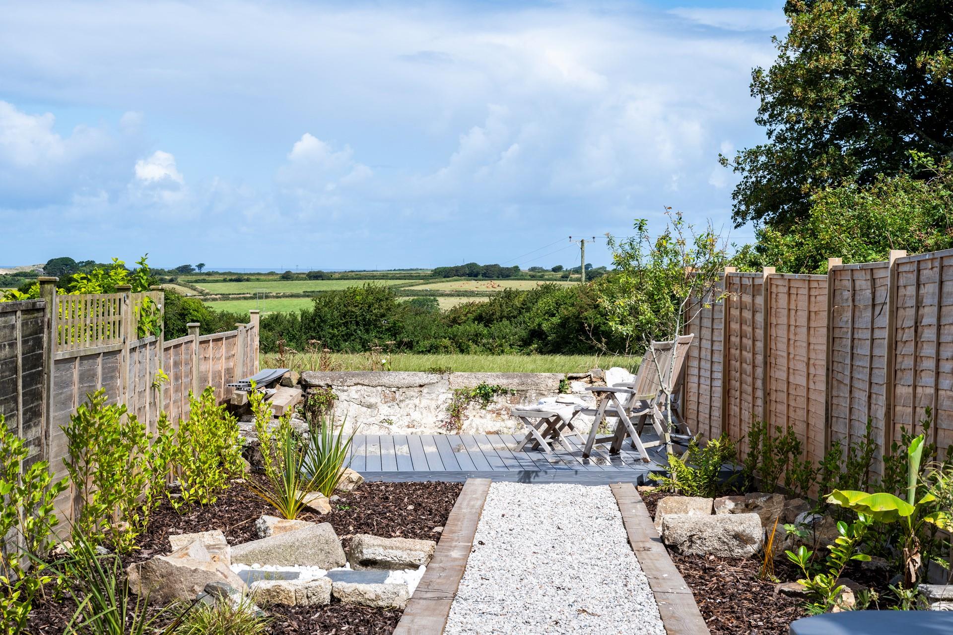 Soak up the sunshine on the decking at the end of the garden.