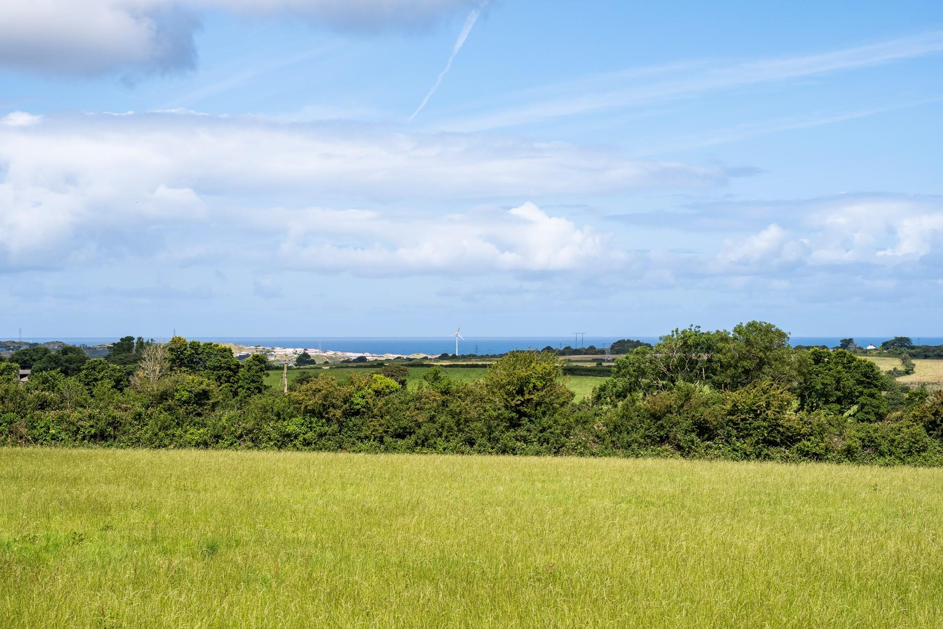 Enjoy far-reaching views across the field towards the sea.
