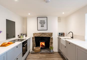 The modern kitchen is well-equipped for cooking hearty meals, with the woodburner roaring in the background, so cosy!
