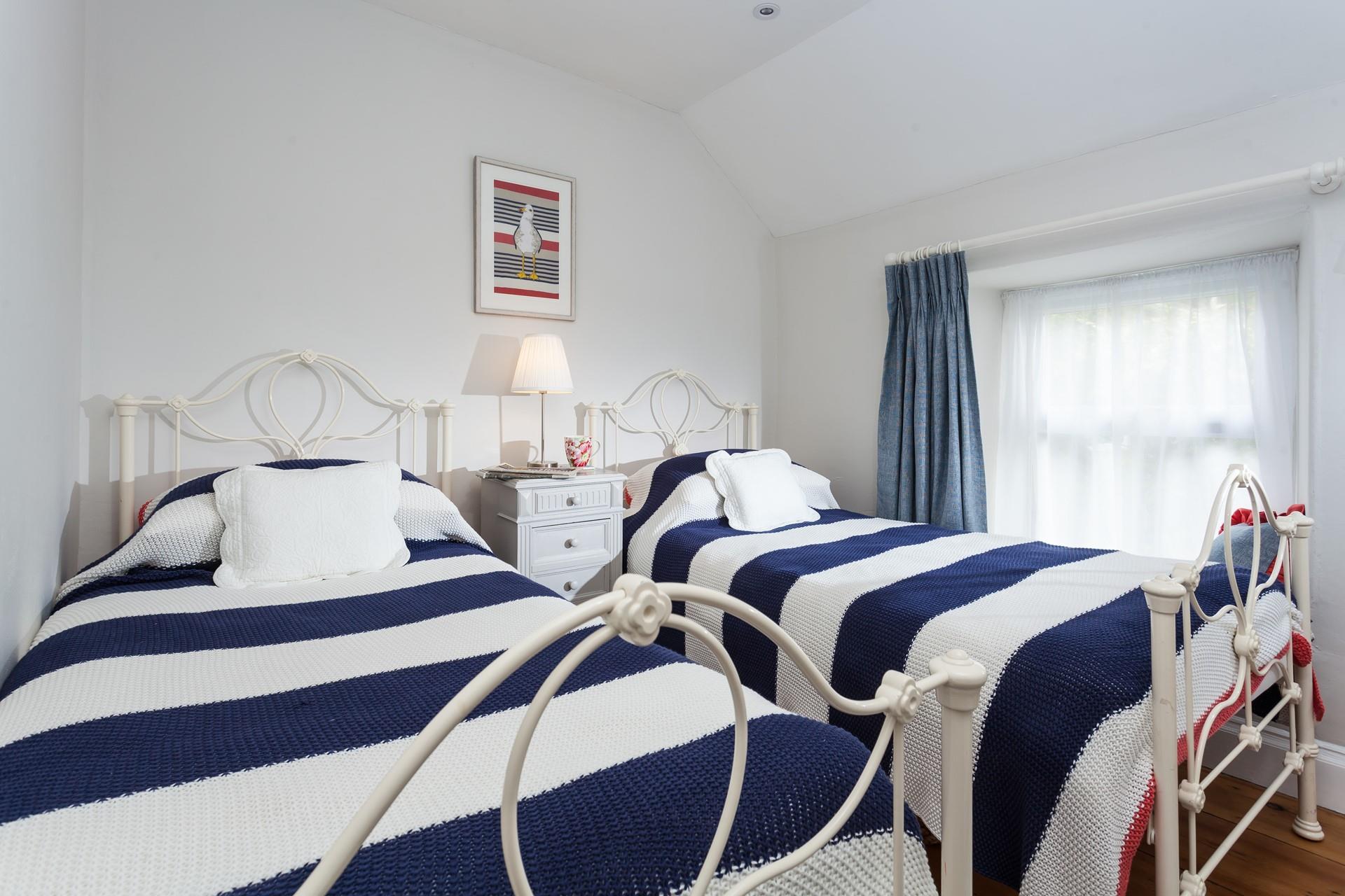Bedroom 2 has a charming nautical theme.