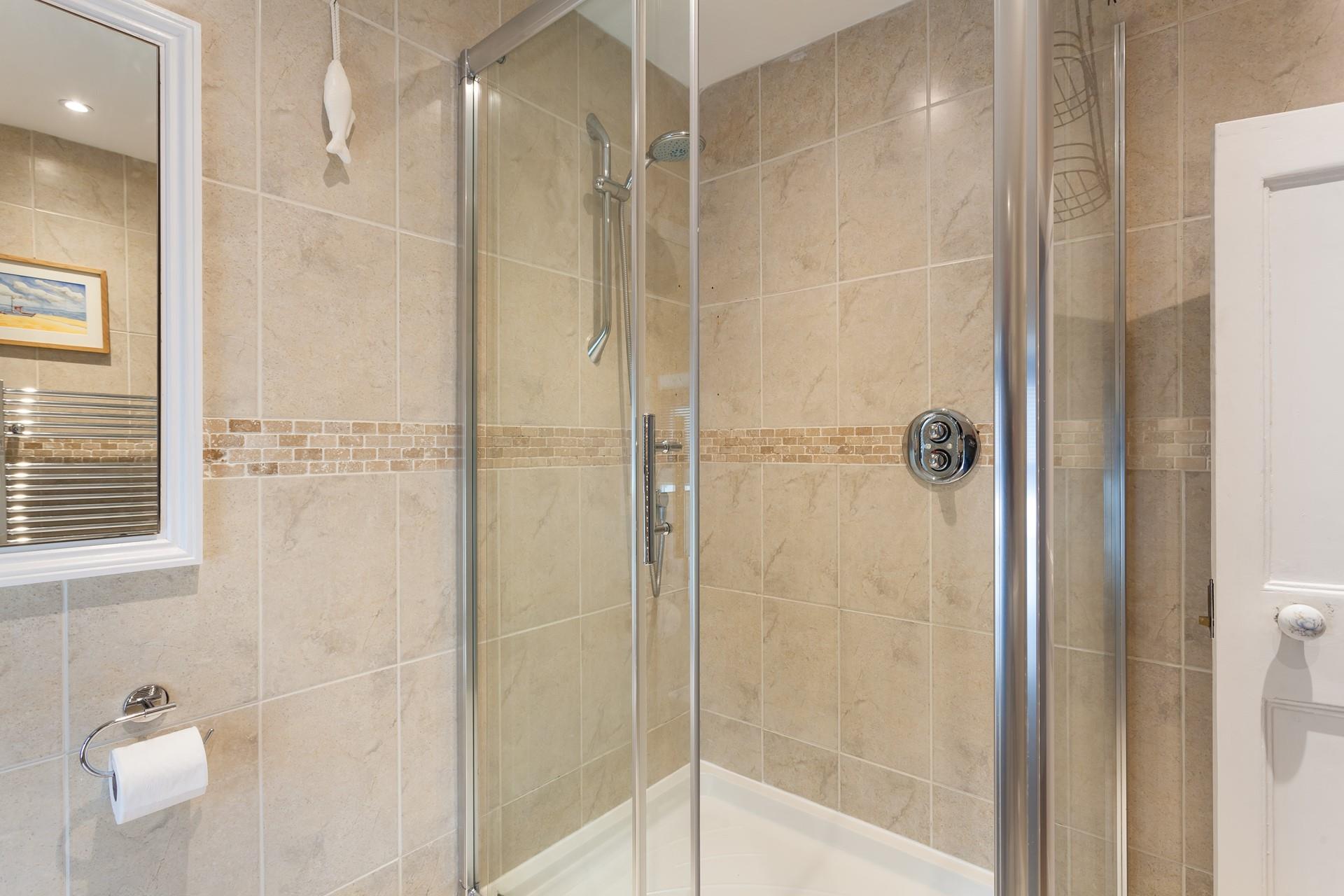 Step into the walk-in shower for a refreshing rinse after a coastal hike.