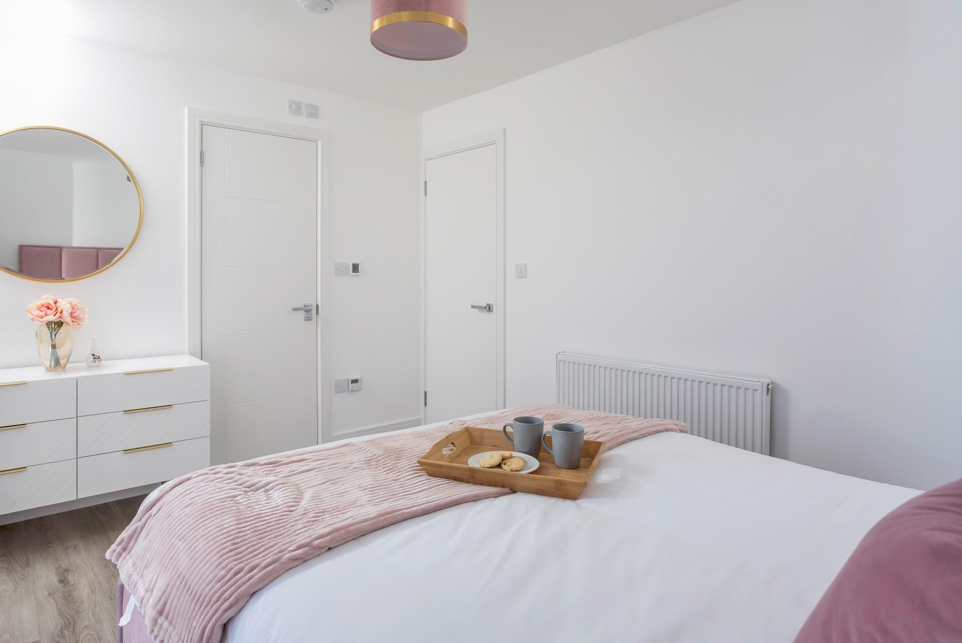 A restful night's sleep awaits in this serene, pastel bedroom.