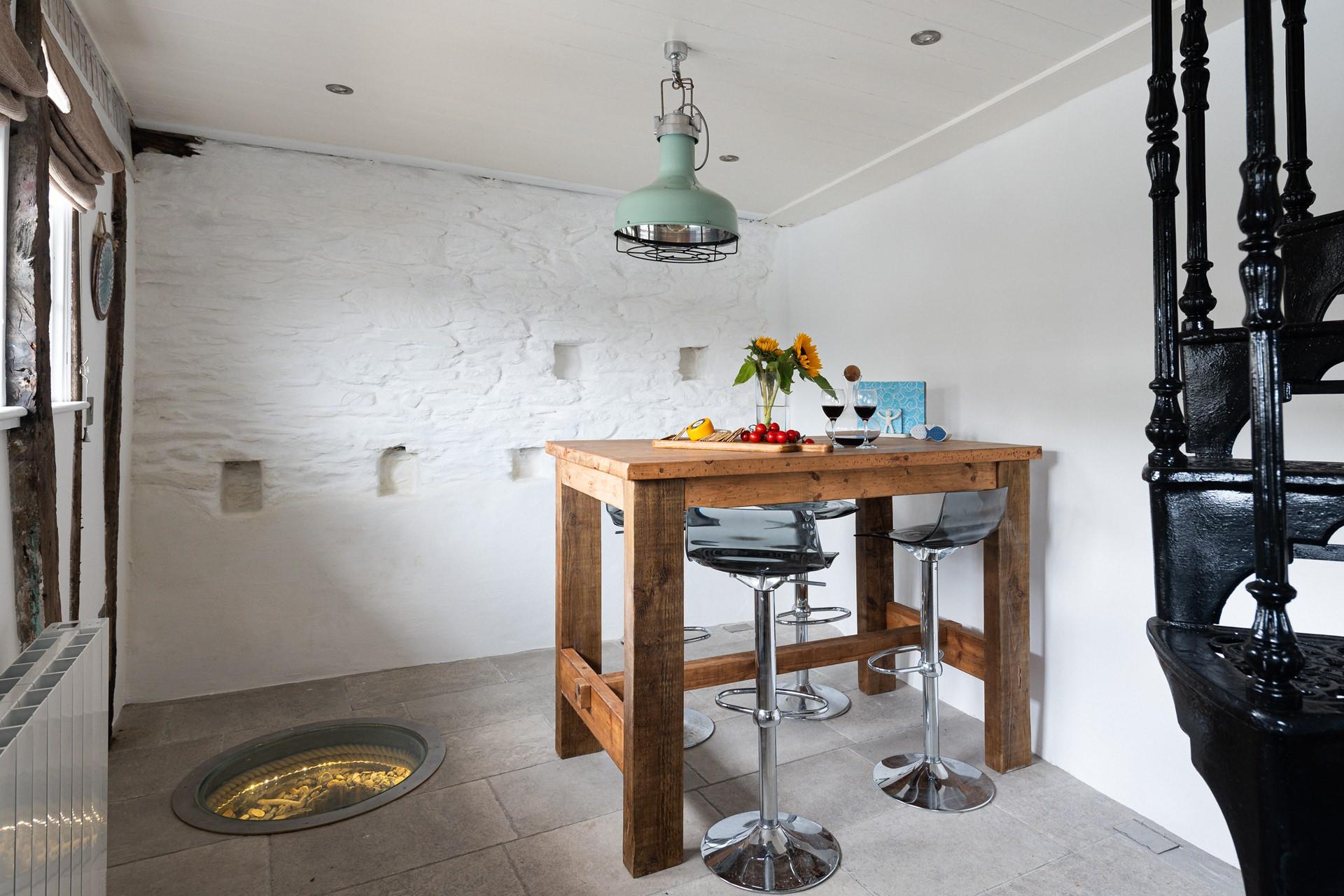 Take a peek through the porthole window in the floor to the old pilchard press, where the catch of the day used to be brought in.