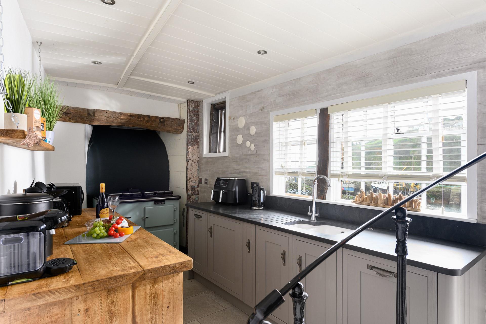 An ornate spiral staircase, an original feature, takes you to the sea-facing living area.