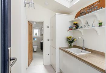 The utility room offers additional space and a washing machine and tumble dryer.