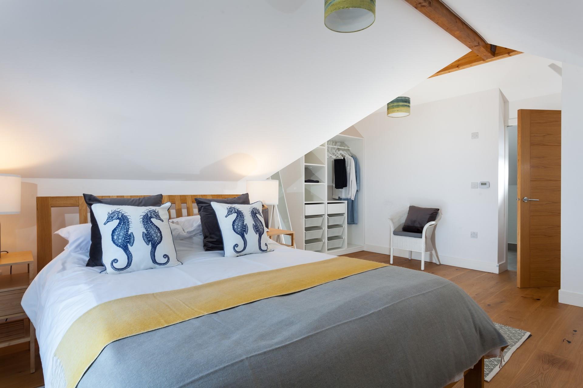 Bedroom 3 has a spacious king size bed and is decorated with seaside tones.